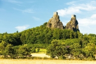 Zwei Burgen auf grünem Hügel mit blauem Himmel im Hintergrund