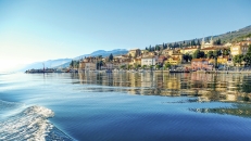 Blick vom Wasser auf die Stadt am Hang